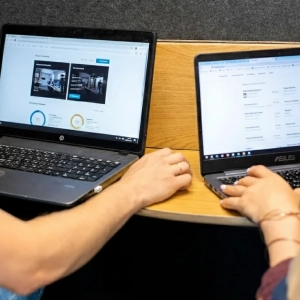two laptops on a foldable table