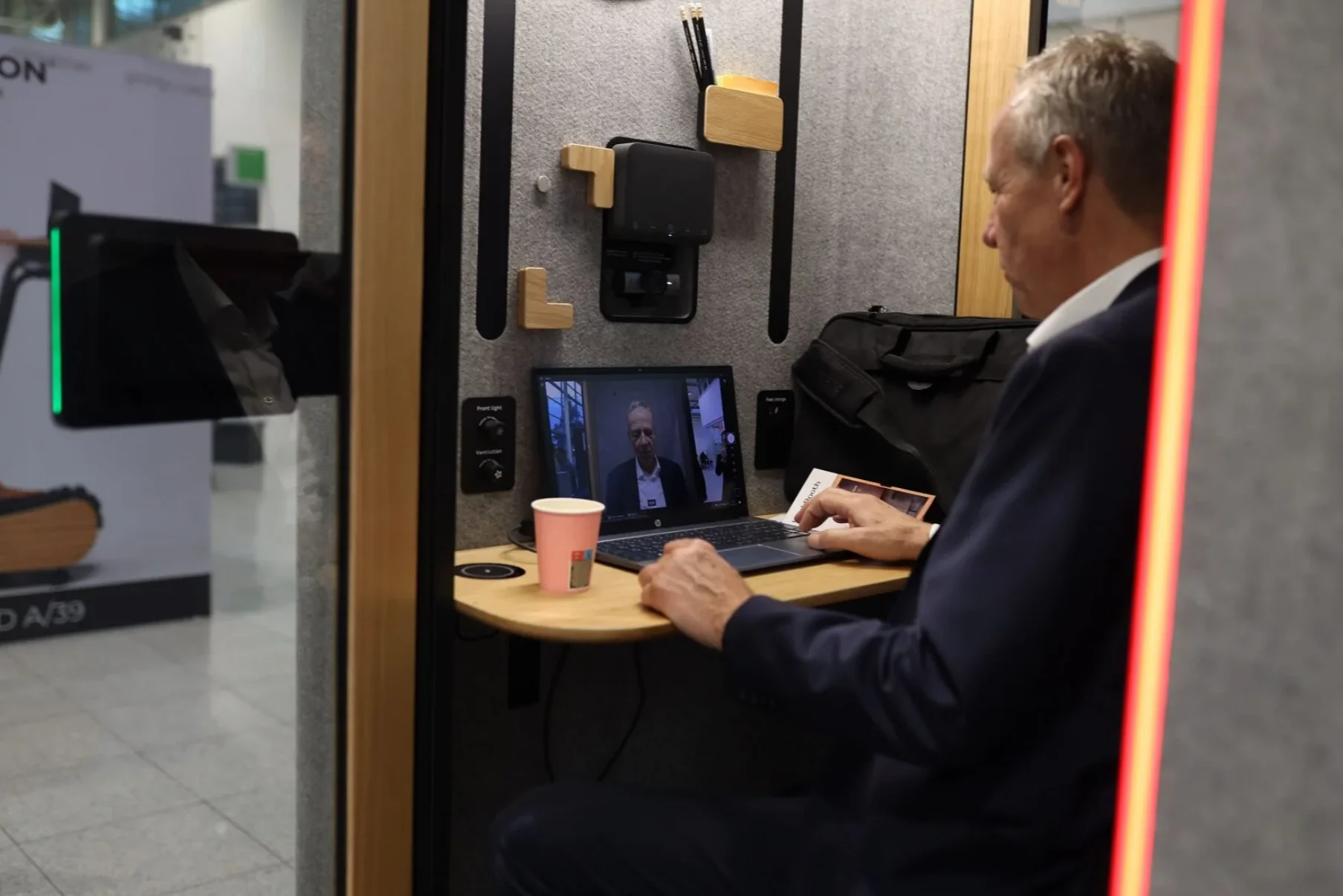 A man is making a video call in a soundproof WorkBooth